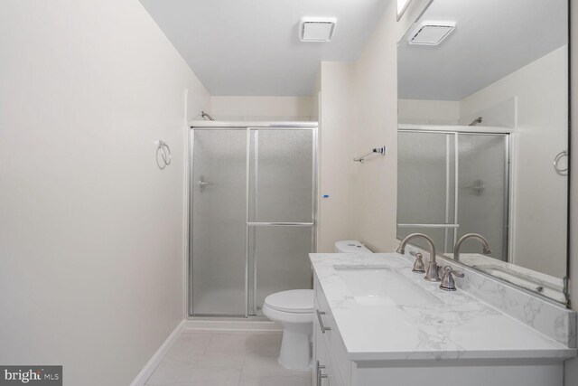 bathroom featuring vanity, toilet, marble finish floor, baseboards, and a shower stall