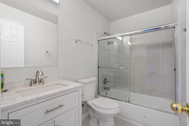 full bathroom with vanity, enclosed tub / shower combo, and toilet