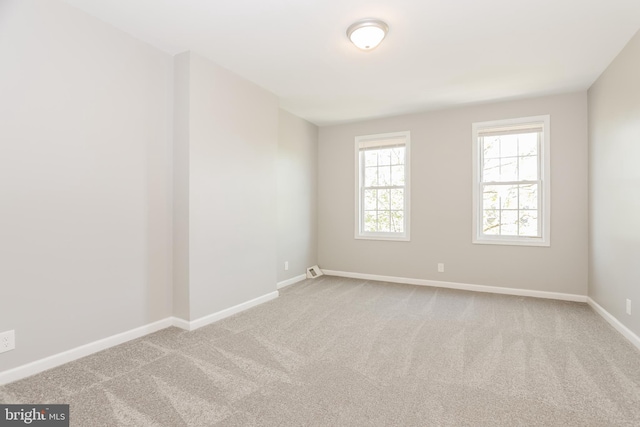 3429 E Lombard St, Baltimore, MD 21224 - carpeted spare room with baseboards