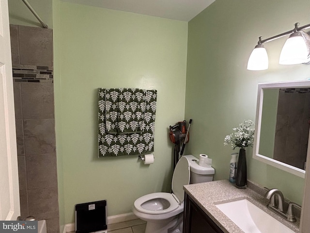 bathroom featuring walk in shower, tile patterned flooring, toilet, vanity, and baseboards
