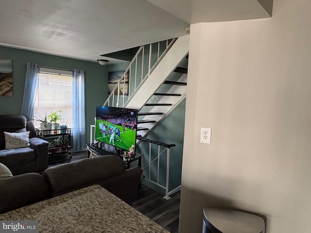 living room featuring stairs, wood finished floors, and baseboards