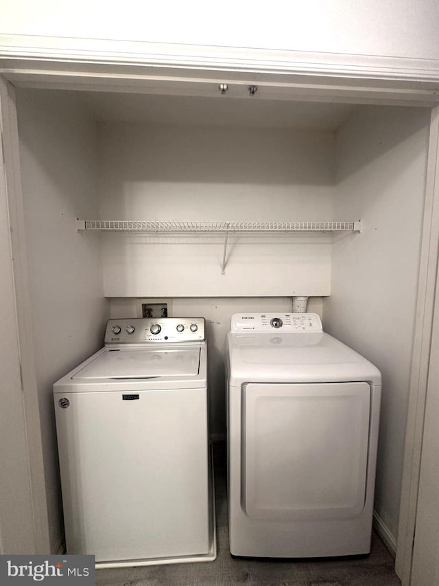 laundry area with washing machine and clothes dryer and laundry area