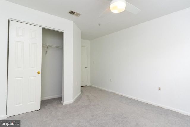 unfurnished bedroom with visible vents, a closet, baseboards, a ceiling fan, and carpet