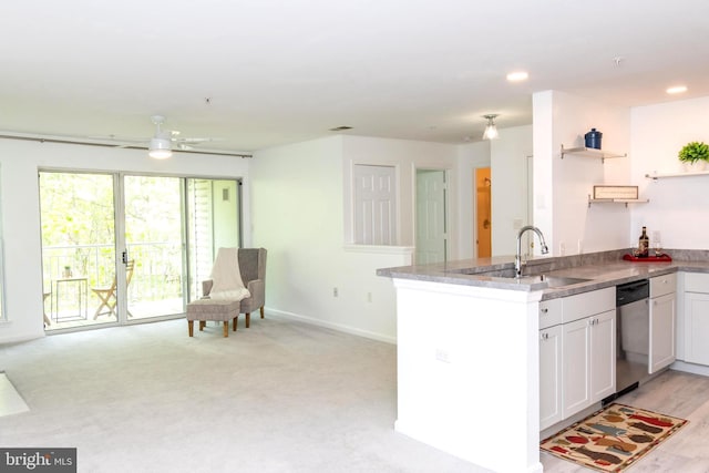 kitchen with stainless steel dishwasher, open shelves, ceiling fan, white cabinetry, and a sink