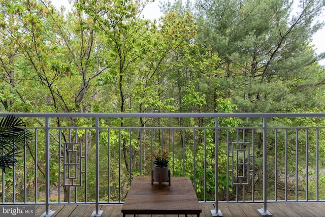 balcony featuring a forest view