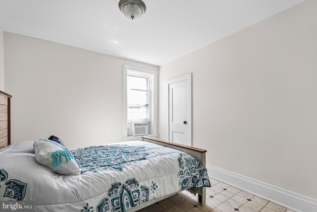 bedroom featuring baseboards and cooling unit