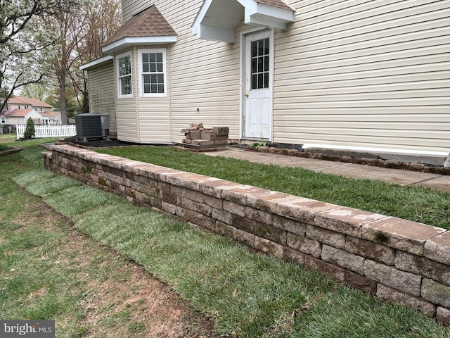 exterior space featuring central AC, a shingled roof, and fence