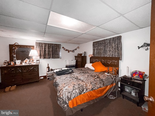 bedroom featuring a paneled ceiling and carpet floors