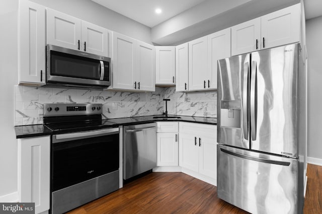 5210 Arch St, Philadelphia, PA 19139 - kitchen featuring dark countertops, a sink, backsplash, and appliances with stainless steel finishes