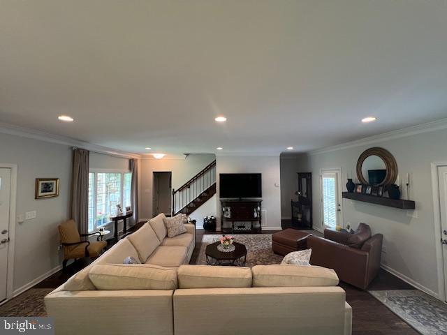 living area with stairs, crown molding, baseboards, recessed lighting, and dark wood-style floors