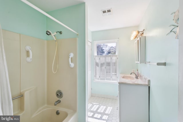 bathroom with baseboards, visible vents, tile patterned flooring, vanity, and bathtub / shower combination