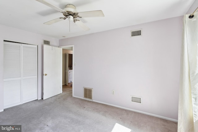 unfurnished bedroom with carpet, visible vents, and a closet