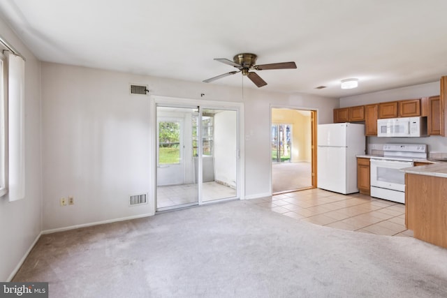 kitchen featuring light carpet, white appliances, and visible vents