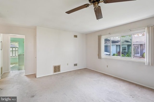 unfurnished room featuring a ceiling fan, carpet flooring, and visible vents