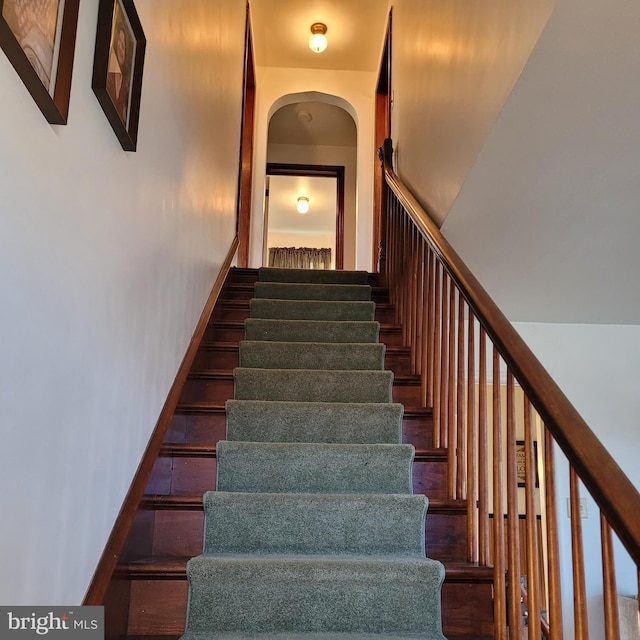 staircase with arched walkways