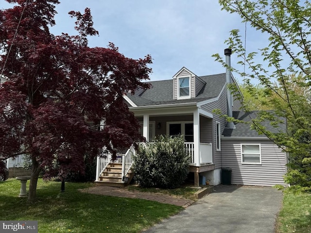 354 Monroe Ave, Glenside, PA 19038 - cape cod home with covered porch, a front lawn, and a shingled roof