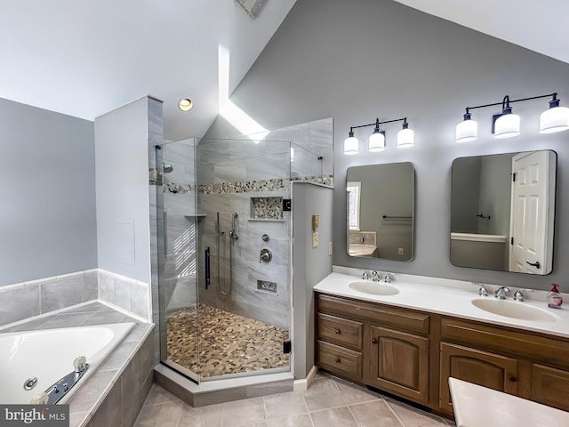 full bathroom with a sink, a bath, a stall shower, vaulted ceiling, and tile patterned flooring