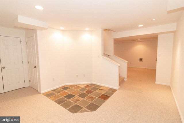 finished below grade area featuring baseboards, recessed lighting, stairs, and carpet floors