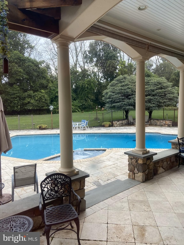 view of swimming pool with a patio, a fenced in pool, and a fenced backyard