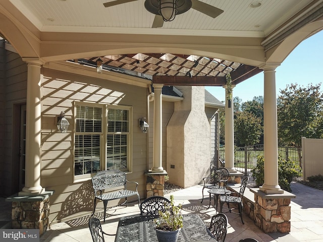 view of patio / terrace featuring ceiling fan and fence