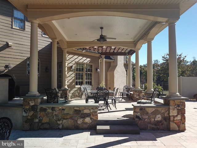 view of patio featuring fence, outdoor dining space, and a ceiling fan