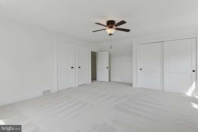 unfurnished bedroom featuring visible vents, ceiling fan, baseboards, and light carpet