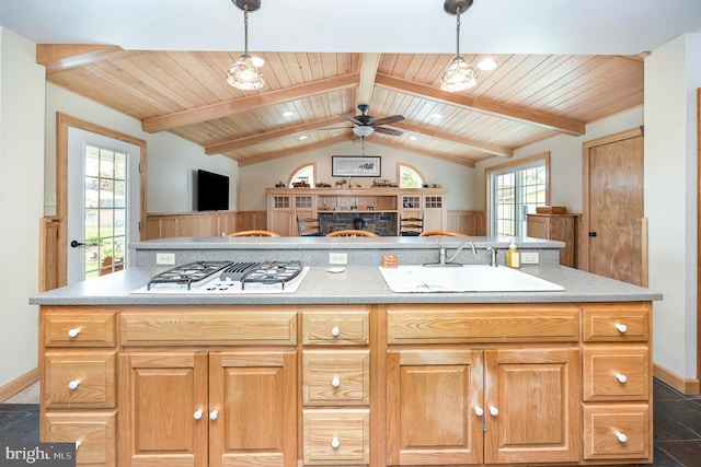 kitchen featuring wooden ceiling, ceiling fan, white gas stovetop, a sink, and open floor plan