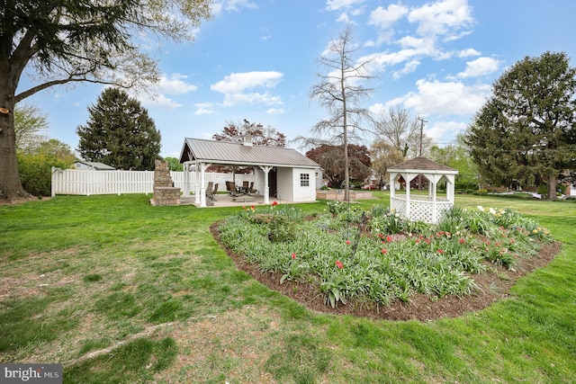 view of yard with fence, a gazebo, and a patio