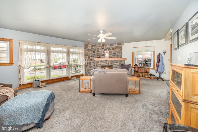 living room featuring a healthy amount of sunlight, a ceiling fan, and carpet