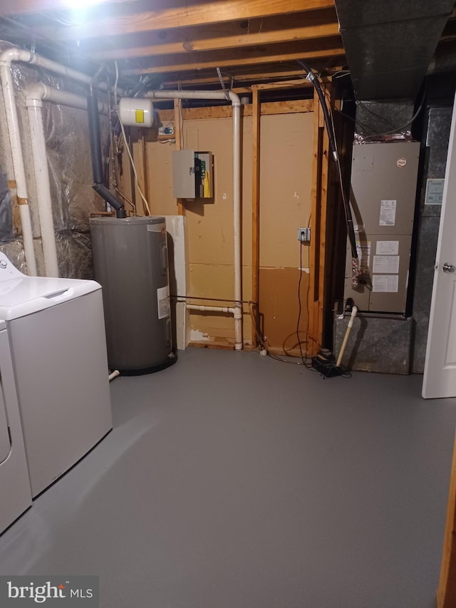 unfinished below grade area with water heater, heating unit, and washing machine and clothes dryer