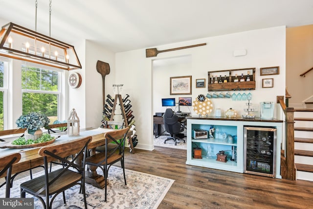 1579 Meadowlark Glen Rd, Dumfries, VA 22026 - dining space featuring dark wood finished floors, stairway, a bar, beverage cooler, and a notable chandelier