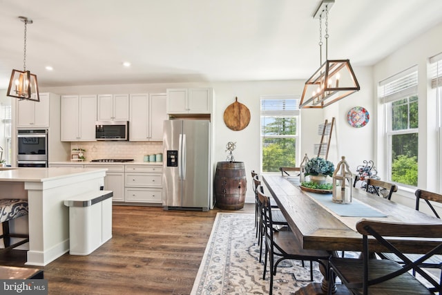 1579 Meadowlark Glen Rd, Dumfries, VA 22026 - kitchen with backsplash, stainless steel appliances, dark wood finished floors, and plenty of natural light