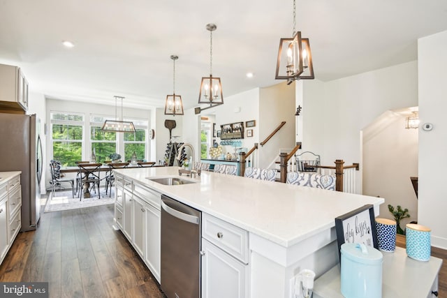 1579 Meadowlark Glen Rd, Dumfries, VA 22026 - kitchen with a center island with sink, dark wood-type flooring, light countertops, a sink, and stainless steel appliances