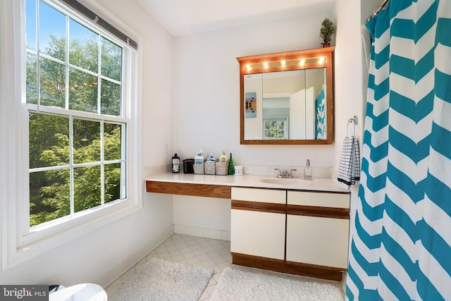24 Amarillo Ct Unit 125, Germantown, MD 20874 - bathroom with healthy amount of natural light, tile patterned flooring, vanity, and curtained shower