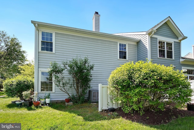 24 Amarillo Ct Unit 125, Germantown, MD 20874 - rear view of property with a chimney, a yard, and central AC unit
