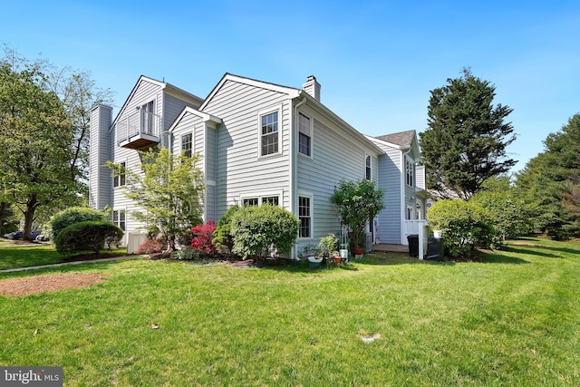 24 Amarillo Ct Unit 125, Germantown, MD 20874 - view of property exterior with a chimney and a lawn
