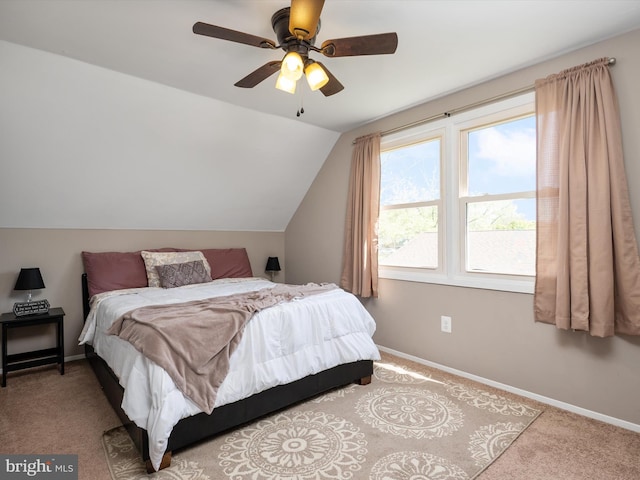 bedroom with baseboards, carpet flooring, a ceiling fan, and lofted ceiling