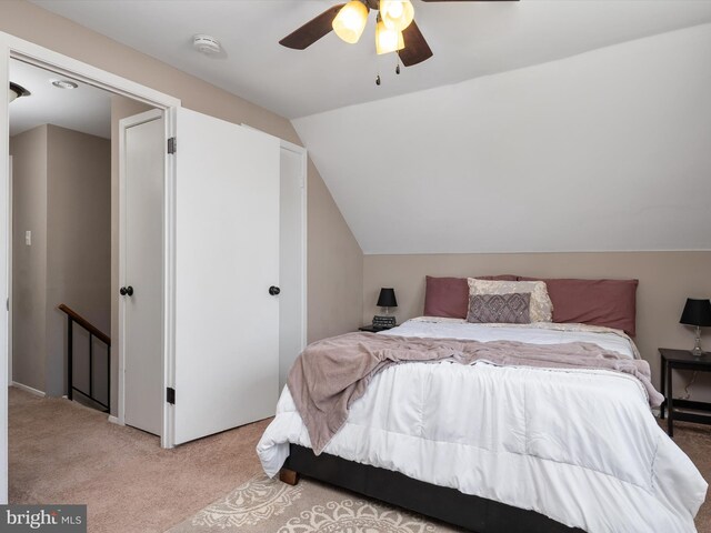 bedroom featuring light colored carpet, a ceiling fan, and lofted ceiling