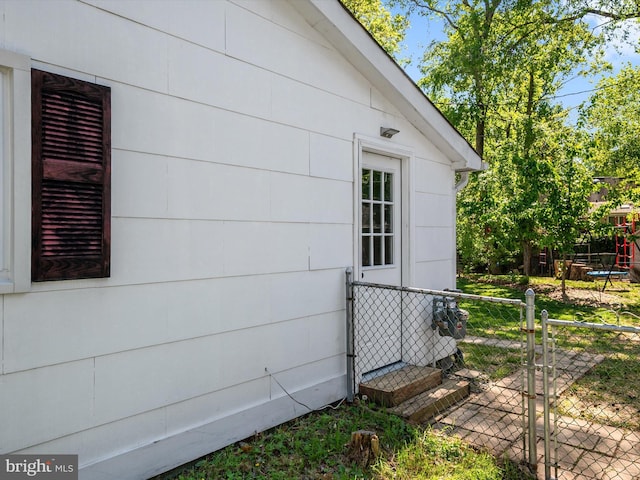 view of home's exterior featuring fence and a gate