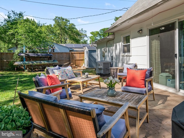 view of patio featuring central AC, an outdoor living space, and a fenced backyard