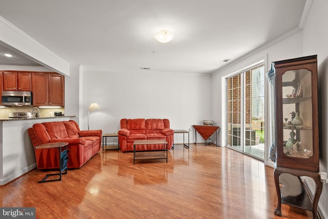 400 Cameron Station Blvd Unit 105, Alexandria, VA 22304 - living room with light wood finished floors, ornamental molding, and baseboards
