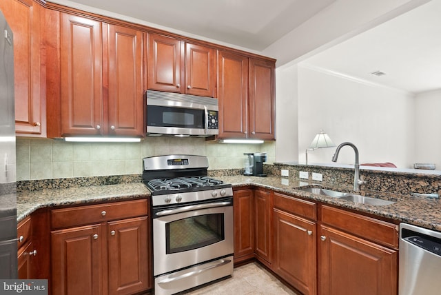 400 Cameron Station Blvd Unit 105, Alexandria, VA 22304 - kitchen featuring appliances with stainless steel finishes, a sink, backsplash, dark stone counters, and ornamental molding