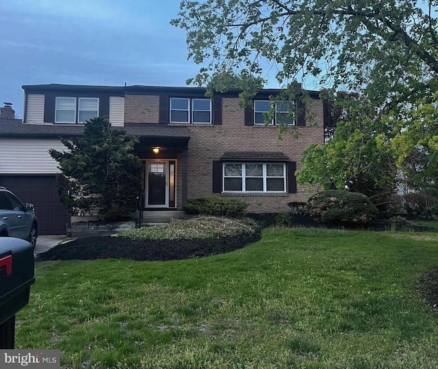 view of front facade featuring brick siding and a front yard