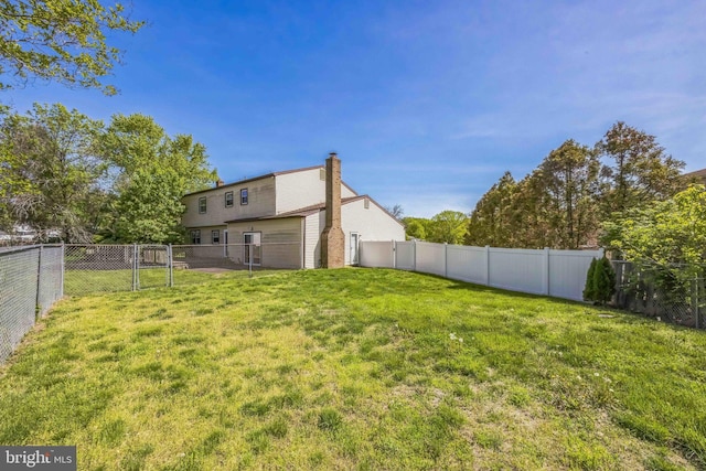 view of yard featuring a gate and a fenced backyard