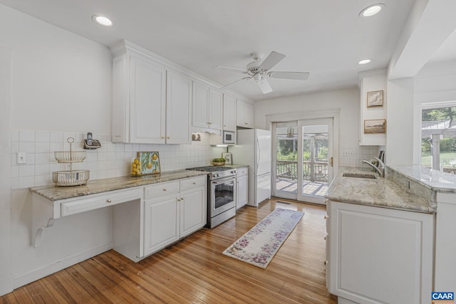 kitchen featuring white appliances, a sink, white cabinetry, ceiling fan, and recessed lighting