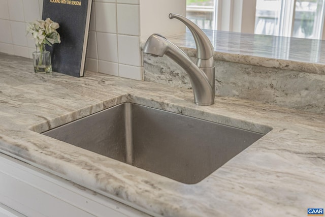 kitchen view of a sink and backsplash