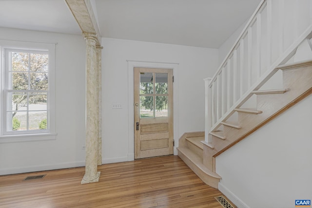 entrance foyer featuring light wood finished floors, stairway, and baseboards