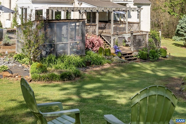 view of grassy yard featuring a deck and a pergola