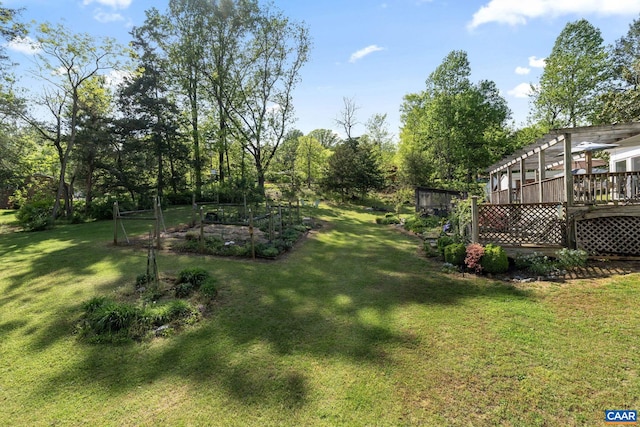 view of grassy yard with a deck