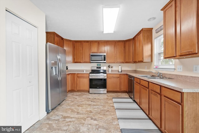 11 Gooseneck Ln, Smyrna, DE 19977 - kitchen featuring appliances with stainless steel finishes, a sink, light countertops, and brown cabinetry